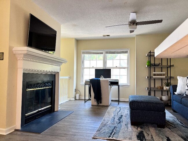 Living room view: alternate view from dining area. - 704 Rapidan River Ct