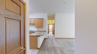Located at 39W250 Herrington Blvd in Geneva, IL, this well-appointed 3-bedroom, 2-bathroom single-floor residence offers a thoughtfully designed layout with quality finishes throughout. The kitchen serves as a functional centerpiece, featuring warm maple cabinetry, granite countertops, a peninsula for additional prep space, and a full suite of stainless steel appliances including a gas range, microwave, dishwasher, and a French door refrigerator. Light-tone tile flooring completes the space. The bedrooms are carpeted and benefit from vaulted ceilings that lend an open, airy feel. The primary bedroom is generously sized and includes a walk-in closet outfitted with wire shelving systems for organized storage. Bedrooms are brightened by wood-trimmed windows, with some rooms featuring dual windows and ceiling fans. The bathrooms are finished with granite-topped vanities and wood cabinetry, with one bathroom offering a tub/shower combo. A dedicated laundry room with tile flooring provides added convenience, and consistent warm wood trim and baseboards tie together the clean, neutral aesthetic found throughout the home.