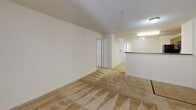 Located at 15 Castleknock Dr in Asheville, NC, this single-story home presents a straightforward, functional layout suited for comfortable everyday living. The entryway transitions from tile flooring into a generously sized living area finished with patterned carpeting, which continues throughout the main living and bedroom spaces, contributing a warm, cohesive feel across the floor plan.

The kitchen is well-equipped with warm-toned wood cabinetry, dark granite-style countertops, and a full suite of black appliances including a refrigerator, electric range, built-in microwave, and dishwasher. Light tile flooring, ample cabinet storage, and a double-basin sink with a peninsula create an efficient and practical cooking space that opens toward the main living area, promoting an open feel.

The bedroom features a ceiling fan, a window with blinds for natural light and privacy, and direct access to a spacious walk-in closet outfitted with wire shelving for organized storage. The bathroom includes tile flooring, a wood-cabinet vanity with a single sink and lighted mirror, and a full soaking tub with a shower curtain rod. Neutral tones and clean finishes throughout give the home a move-in ready appearance.