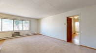 Located at 4430 Chowen Ave S in Minneapolis, MN, this 3-bedroom, 1-bathroom unit offers a practical and well-organized single-floor layout. The space features a mix of warm hardwood flooring throughout the common areas and bedrooms, while the primary bedroom is finished with plush carpet for added comfort. The primary bedroom is generously sized, offering ample space, and is complemented by a wall-unit air conditioner and a large window that brings in natural light.

The additional bedrooms are bright and airy, each with hardwood floors, baseboard heating, and windows overlooking the surrounding greenery. One bedroom features a mirrored sliding closet door alongside a wood-paneled closet, offering smart storage solutions. The kitchen is efficiently designed with warm oak cabinetry, granite-style countertops, hardwood floors, and black stainless steel appliances including a gas range, microwave, and refrigerator. The full bathroom includes a tiled tub-shower surround in clean white. A central hallway connects all rooms, contributing to a cohesive and easy-to-navigate floor plan. Baseboard heating is present throughout, ensuring year-round comfort in this Minneapolis residence.