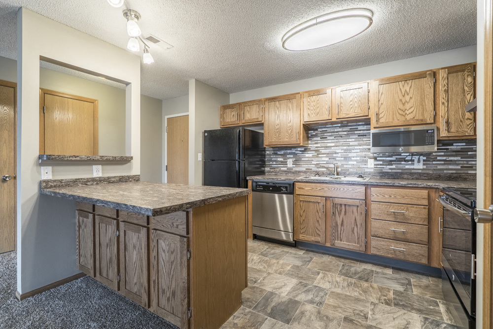 Our renovated apartments feature updated cabinetry, countertops, appliances and tile backsplash. - Highland View Apartments