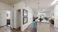 This single-story, one-bedroom, one-bathroom residence at 1405 Southwood Plantation Rd offers a thoughtfully designed layout with modern finishes throughout. The open-concept kitchen flows directly into the living area, creating a connected and functional living space. The kitchen is equipped with stainless steel appliances, including a refrigerator, electric range, and built-in microwave, complemented by rich dark cabinetry, granite-style countertops, and wood-look flooring. A peninsula with seating provides additional counter space and casual dining options, with a pendant light overhead.

The living room features a ceiling fan, large windows that invite natural light, and wood-look flooring that extends from the kitchen, contributing to a cohesive aesthetic throughout the common areas.

The bedroom is carpeted for comfort, includes a ceiling fan, a dedicated closet, and windows with blinds and drape panels. It connects directly to the bathroom, which features a wide vanity with granite-style counters, dark cabinetry, a large mirror, and a shower-tub combination. The bathroom also offers wood-look flooring, consistent with the rest of the unit's design language.

Overall, the space presents a clean, modern aesthetic with warm tones and efficient use of its footprint.