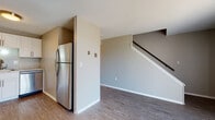 Located at 279 Amherst Rd in Sunderland, Massachusetts, this two-floor residence offers a well-organized layout with updated finishes throughout. The main level features durable hardwood-style flooring that extends through the open living area and into the kitchen. The kitchen is thoughtfully designed with white cabinetry, light granite-style countertops, and a full suite of stainless steel appliances, including a refrigerator, dishwasher, and range. A staircase off the main living area connects the two floors, and a conveniently located bathroom on this level includes a white vanity with storage and a tiled shower area. The living spaces on the main floor are bright and open, with natural light filtering in through windows. Upstairs, the bedrooms are carpeted for comfort and feature neutral wall tones. One bedroom includes a built-in closet with louvered doors, while another offers views of the surrounding greenery through a broad window. A second bathroom upstairs echoes the clean, functional design seen throughout, with a white vanity and medicine cabinet. Baseboard heating is present throughout both floors. The overall aesthetic is clean and neutral, providing a versatile canvas well-suited to a variety of living arrangements.