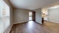 Located at 3609 Forrest Ave in Memphis, Tennessee, this single-story 2-bedroom, 1-bathroom home offers a practical and well-organized layout. Dark hardwood-style flooring runs consistently throughout the home, complemented by neutral gray walls, white trim, and textured ceilings that create a clean, cohesive aesthetic.

The open-concept living room flows directly into the kitchen, making the shared space functional and welcoming. The kitchen is equipped with white cabinetry extending to the ceiling, granite-style countertops, a double sink, and black appliances including a range and refrigerator, with a window above the sink bringing in natural light.

Both bedrooms feature the same durable flooring and neutral tones, with windows fitted with blinds that allow natural light while maintaining privacy. The primary bedroom offers a generous footprint and includes closet access. The second bedroom is similarly sized and well-lit. In total, four closets are distributed throughout the home, providing excellent storage capacity.

Additional functional spaces include a dedicated laundry room, a utility room, and a hallway connecting the main areas. The single bathroom completes the layout. The front entry opens into the living area with a decorative security door, adding a layer of character to the home's interior access point.