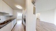 Located on the 7th floor at 86 Cedar St S in Kitchener, Ontario, this one-bedroom, one-bathroom unit offers a well-organized layout across a comfortable and efficiently designed floor plan. The interior is finished with light-toned laminate wood flooring throughout, crisp white walls, and clean white baseboards, giving the space a bright, modern aesthetic.

The open living area is bathed in natural light, featuring a large sliding glass door that opens onto a private balcony overlooking a lush canopy of mature trees — a standout feature offering a tranquil, green outlook from this elevated vantage point. An additional window further enhances the light-filled atmosphere of the living space. Adjacent to the living area, the kitchen is neatly tucked away and features light cabinetry, a subway tile backsplash, and stainless steel appliances.

The bedroom is a well-proportioned private retreat, equipped with a built-in sliding door closet and a window that brings in natural light. The full bathroom includes a soaker tub and shower combination, finished with classic white subway tile surround and chrome fixtures. A hallway connects all rooms, providing a logical and functional flow throughout the unit. The overall ambiance is clean, contemporary, and move-in ready.