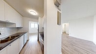 Located on the 7th floor at 86 Cedar St S in Kitchener, Ontario, this one-bedroom, one-bathroom unit offers a well-organized layout across a comfortable and efficiently designed floor plan. The interior is finished with light-toned laminate wood flooring throughout, crisp white walls, and clean white baseboards, giving the space a bright, modern aesthetic.

The open living area is bathed in natural light, featuring a large sliding glass door that opens onto a private balcony overlooking a lush canopy of mature trees — a standout feature offering a tranquil, green outlook from this elevated vantage point. An additional window further enhances the light-filled atmosphere of the living space. Adjacent to the living area, the kitchen is neatly tucked away and features light cabinetry, a subway tile backsplash, and stainless steel appliances.

The bedroom is a well-proportioned private retreat, equipped with a built-in sliding door closet and a window that brings in natural light. The full bathroom includes a soaker tub and shower combination, finished with classic white subway tile surround and chrome fixtures. A hallway connects all rooms, providing a logical and functional flow throughout the unit. The overall ambiance is clean, contemporary, and move-in ready.