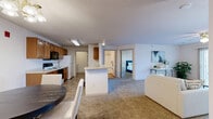Located at 15600 Galaxie Ave in Apple Valley, MN, this 2-bedroom, 2-bathroom residence offers a thoughtfully designed single-floor layout with generous living space. The open-concept main area seamlessly connects the kitchen, dining room, and living room, creating an inviting and functional hub for daily life. The living room features plush carpeting, a ceiling fan, and a sliding glass door with vertical blinds that fills the space with natural light. The kitchen is well-appointed with warm wood cabinetry, light countertops, tile flooring, a full suite of appliances including an electric range, built-in microwave, dishwasher, and refrigerator, and a peninsula that overlooks the dining area. Both bedrooms are carpeted and include ceiling fans, with the spacious primary bedroom offering ample room for furnishings. Each bathroom is equipped with a tub-shower combination and warm-toned tile flooring. The residence also includes a dedicated laundry room with a full-size washer and dryer. Four closets throughout the unit provide excellent storage capacity. The overall ambiance is comfortable and practical, making this a well-rounded home in a residential Apple Valley community.