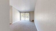 Located in San Marcos, California, this well-appointed 2-bedroom, 3-bathroom residence offers a comfortable and thoughtfully designed layout across a single floor. The living room is an inviting space highlighted by soaring vaulted ceilings, a ceiling fan, and a sliding glass door that opens to a private balcony overlooking lush, tree-lined grounds with palm trees and a sunny Southern California sky — ideal for relaxing or enjoying the outdoors. Soft carpeting runs throughout the living and bedroom areas, contributing to a warm and quiet atmosphere.

The kitchen has been tastefully updated with white shaker-style cabinetry, clean white quartz countertops, a classic subway tile backsplash, recessed lighting, and light wood-style flooring — creating a bright and functional cooking space. A window above the sink brings in natural light.

Both bedrooms are generously proportioned, featuring plush carpet, vertical blinds, and ample natural light from large windows. The hallway connects the rooms seamlessly, with wood-style flooring and built-in storage adding practicality. Three bathrooms serve the home, with at least one featuring a clean, all-white walk-in shower with chrome fixtures. The overall aesthetic is neutral, clean, and move-in ready.