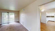 Located at 508 Norseman Dr in Jeffersonville, Indiana, this single-floor residence offers a well-organized layout with a thoughtful mix of flooring, finishes, and functional living spaces throughout.

The kitchen is a standout feature, showcasing white shaker-style cabinetry extending to the upper walls, granite-look countertops, and a striking mosaic tile backsplash in earthy brown and neutral tones. White appliances including a range, dishwasher, and refrigerator are complemented by warm hardwood-style flooring, creating a clean and inviting cooking space brightened by natural light from a nearby window.

The living area is generously sized with plush carpeting and textured ceilings, and opens directly to a private balcony through sliding glass doors, bringing in natural light and outdoor views. A ceiling fan light fixture adds comfort to the adjoining dining or flex space, which also features hardwood-style flooring and a closet.

The bedrooms are comfortably sized, each with soft carpeting, neutral walls, and windows that allow natural light to filter in. The bathroom is finished with large-format tile flooring, a full tub-shower surround in coordinating tile, a white vanity with granite-style countertop, and brushed nickel fixtures, providing a clean and cohesive aesthetic throughout.