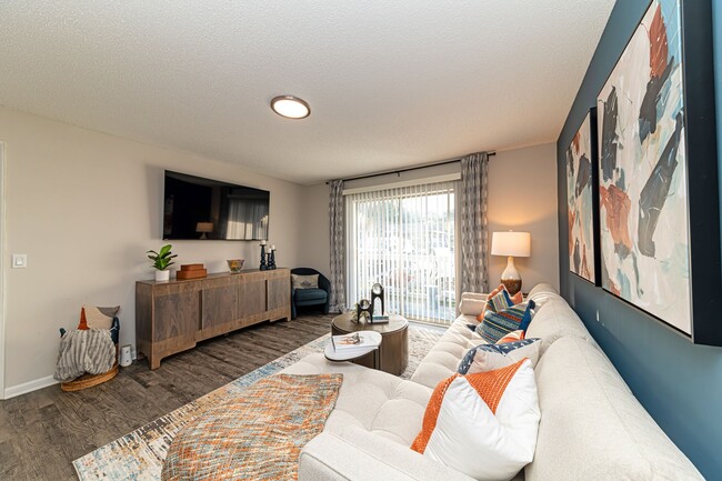 Spacious living room with hardwood-style flooring and overhead lighting - The Linden Apartment Homes