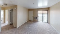 Unit #172 Upstairs Classic at 320 Pomelo in Vista offers a practical and well-organized single-floor layout. The living area is generously sized, featuring neutral-toned carpet, warm beige walls, and a sliding glass door that opens to a private balcony, allowing natural light to fill the space. A wall-mounted AC unit provides climate control directly in the living area.

The kitchen is designed for efficient use of space, featuring wood-toned cabinetry on both sides, laminate countertops, a coil-top electric range with oven, a white refrigerator, a dishwasher, and a double-basin stainless steel sink. Tile flooring runs throughout the kitchen, offering easy maintenance.

The bedrooms are carpeted and finished with the same neutral palette, each equipped with sliding-door closets that provide ample storage. One bedroom features open shelving within the closet for added organization.

The unit includes two bathrooms. The full bathroom offers a tub-shower combination with tiled surround, a vanity with marble-style countertop, and tile flooring. The second bathroom features a single vanity with wood cabinetry, a large mirror with overhead lighting, and matching tile flooring. Together, these rooms deliver a clean, functional living environment in a classic residential setting.