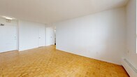 Located at 30 High St E, Suite 605 in Mississauga, Ontario, this one-bedroom, one-bathroom unit offers a well-organized layout across a single floor. Warm parquet flooring flows throughout the living areas and bedroom, lending the space a classic character that pairs well with the clean white walls and bright, open feel.

The living room is generously proportioned, bathed in natural light from large windows that frame views of the surrounding Mississauga cityscape. A baseboard heating system runs along the windowed wall, ensuring year-round comfort. The space provides a welcoming and functional area for everyday living.

The kitchen has been thoughtfully renovated with white shaker-style cabinetry, dark countertops, a white subway tile backsplash, and stainless steel appliances including a range with microwave hood and refrigerator. Large-format white tile flooring completes the clean, modern aesthetic.

The bedroom is a comfortable size, featuring the same warm parquet flooring, crisp white walls, and a sliding-door closet that offers practical storage. The room connects easily to the rest of the unit via a central hallway.

The bathroom is finished with floor-to-ceiling white subway tile surrounding a soaker tub and shower combination with chrome fixtures, creating a clean and timeless look throughout.