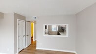 Located at 738 Lake Nora N Ct in Indianapolis, Indiana, this two-floor home offers a clean, neutral aesthetic throughout, with thoughtfully updated finishes that create a welcoming and functional living environment.

The main living area features light wood-look flooring and large sliding glass doors fitted with vertical blinds, allowing generous natural light to fill the space. An adjacent room with similar flooring provides flexible living or dining space. A pass-through window connects the living area to the kitchen, enhancing the open feel between rooms.

The kitchen is well-appointed with dark gray shaker-style cabinetry, bright white countertops, and stainless steel appliances including a refrigerator and dishwasher. A single-basin sink is positioned beneath a window, and light wood-look flooring ties the space together with the rest of the main level.

The bedrooms are carpeted in a neutral tone and feature natural light from windows with blinds. Ample closet space is provided, including a large bi-fold closet. The textured ceilings are consistent throughout the home.

The bathroom includes a full tub-shower combination with white tile surround, a toilet, and a vanity, all finished in a clean, neutral palette. The overall ambiance of the home is bright, understated, and move-in ready.