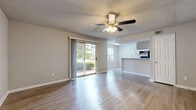 This single-floor, 2-bedroom, 3-bathroom home in Pensacola, Florida offers a well-organized and functional layout designed for comfortable everyday living. The open-concept living and kitchen area serves as the heart of the home, featuring wood-style laminate flooring, neutral warm-toned walls, and a ceiling fan with light fixture. Sliding glass doors provide direct access to the outdoors and allow abundant natural light to fill the space, offering pleasant views of surrounding greenery.

The galley-style kitchen is efficiently designed with white cabinetry, light countertops, a double stainless steel sink, black appliances including an electric range and dishwasher, and a dedicated pantry closet for additional storage. A pass-through counter connects the kitchen to the living area, enhancing the open feel.

The primary bedroom is generously proportioned, featuring sliding glass door access to the exterior, a ceiling fan, and wood-style flooring. The second bedroom is carpeted with a window providing natural light and a ceiling fan overhead. Two closets provide ample storage throughout the home.

All three bathrooms are clean and functional, featuring single vanities with light countertops, tub/shower combinations, and wood-style flooring. The home's neutral color palette and practical design create a bright, easy-to-maintain living environment.