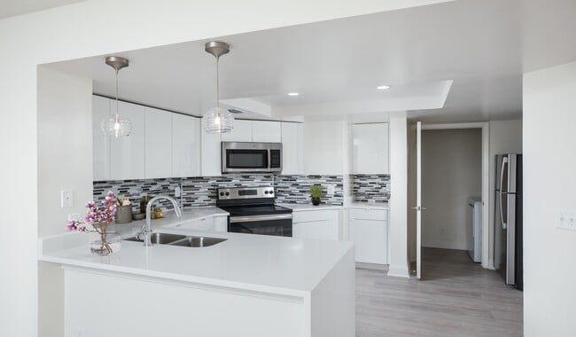 Modern kitchen with stainless steel appliances, granite countertops and designer cabinets - Waterways Village