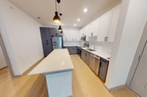 This contemporary apartment, located at 9145 Decker Lake Rd in Austin, TX, offers 1120 square feet of thoughtfully designed living space. The single-story layout encompasses three bedrooms, including a spacious primary bedroom of 170 square feet, and two full bathrooms. The heart of the home is an open-concept kitchen and living area, showcasing a sleek design with a mix of white and gray cabinetry, stainless steel appliances, and a large center island with pendant lighting.

Throughout the apartment, you'll find a cohesive aesthetic with light wood-look flooring in the main living areas and plush carpeting in the bedrooms. Large windows with horizontal blinds allow ample natural light to flood the space, creating a bright and airy atmosphere. The bathrooms feature modern fixtures, including framed mirrors and stylish vanities with ample storage.

The bedrooms are generously sized, with the primary bedroom boasting a ceiling fan for added comfort. Built-in closets with sliding doors provide practical storage solutions. The overall design emphasizes clean lines and a neutral color palette, allowing for easy personalization. This well-appointed apartment combines functionality with contemporary style, offering a comfortable and modern living experience in the heart of Austin.