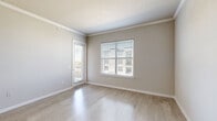 Located at 26493 E University Dr in Little Elm, TX, this single-story, one-bedroom, one-bathroom unit offers a well-designed layout that maximizes every square foot of its compact footprint. Light wood-style flooring runs throughout the living areas and bedroom, complemented by crisp white crown molding and neutral gray walls that create a clean, contemporary aesthetic.

The open-concept kitchen is a standout feature, showcasing dark espresso cabinetry, granite countertops, a peninsula with a double stainless steel sink and bar seating, pendant lighting, track lighting, a tile backsplash, and a full suite of stainless steel appliances including a refrigerator, range, and microwave. A pantry provides additional storage convenience.

The living area benefits from generous natural light through large windows fitted with blinds and direct access to a private balcony. The spacious primary bedroom features a dedicated closet, a window with exterior views, and direct access to the full bathroom. The bathroom mirrors the kitchen's design language with a dark vanity, granite countertop, a well-lit mirror, and tiled shower surround. A dedicated laundry area rounds out the functional offerings of this thoughtfully appointed unit.