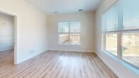Located at 4300 Frederick Ave in Baltimore, MD, this one-bedroom unit offers a well-designed, single-level layout with a clean, modern aesthetic throughout. Light-toned luxury vinyl plank flooring runs continuously across all rooms, complementing the neutral, light-colored walls and creating a bright, cohesive feel.

The open-concept kitchen and living area serves as the heart of the unit. The kitchen is outfitted with rich, dark-stained wood cabinetry extending to near ceiling height, white quartz countertops, a classic white subway tile backsplash, and a full suite of stainless steel appliances including a gas range, microwave, dishwasher, and refrigerator. A central kitchen island with a crisp white finish provides additional prep space and seating potential. Pendant lighting above the island adds a polished touch. The living area receives ample natural light through multiple windows with outdoor views.

The bedroom is a comfortable, well-proportioned space featuring multiple windows that invite natural light and offer views of the surrounding neighborhood. It connects directly to a dedicated walk-in closet equipped with wire shelving and hanging rods, offering practical storage. Clean white walls, white trim, and consistent flooring carry the modern aesthetic throughout the private quarters.