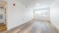 Located at 1102 Victorian Ave in Sparks, Nevada, this thoughtfully designed single-floor residence offers a clean, modern aesthetic throughout. The open-concept living and kitchen area is anchored by warm wood-style plank flooring that flows seamlessly from the living space into the kitchen. Large windows invite natural light into the living room, creating a bright and welcoming atmosphere.

The kitchen is well-appointed with crisp white shaker-style cabinetry, granite-look countertops, and a full suite of stainless steel appliances, including a range, over-the-range microwave, and refrigerator. A peninsula provides additional counter space and a casual dining option, connecting the kitchen to the open living area.

The bedroom features soft carpeting, a generous window with natural light, and a closet. Two bathrooms serve the unit — one with a vanity, large mirror, and wood-style flooring, and a second full bathroom with a soaking tub and shower combination, also finished with wood-style flooring and white cabinetry.

A dedicated laundry nook houses a stacked front-loading washer and dryer, adding everyday convenience. Throughout the unit, white walls and recessed lighting contribute to a clean, contemporary feel that is both functional and inviting.