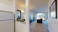 Located at 511 John Muir Dr in San Francisco's Lakeshore neighborhood, this single-floor unit offers a well-organized layout designed for comfortable everyday living. The open-concept design connects the kitchen and living areas, creating a cohesive and functional flow throughout the space.

The kitchen features white cabinetry, granite-style countertops, a stainless steel sink, and a white electric range. A pass-through counter with bar seating connects the kitchen to the adjoining area, enhancing its open feel and making it practical for both cooking and entertaining.

The living area is carpeted and bathed in natural light from a large sliding glass door that opens to a private balcony. The balcony offers views of the surrounding mature trees, providing a calm, nature-facing outlook. This seamless indoor-outdoor connection is a notable feature of the space.

The bedroom is generously proportioned, also carpeted, and benefits from abundant natural light through wide sliding glass doors that open to the balcony. A hallway leading to the bedroom includes built-in shelving for additional storage. The bathroom features granite-style countertops and white cabinetry. Throughout the unit, white walls and neutral tones create a bright, clean aesthetic.