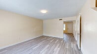 Located on Atlantic Blvd in Jacksonville, FL, this two-story home offers 3 bedrooms and 2 bathrooms thoughtfully distributed across two equally sized floors. The layout includes a kitchen, hallway, staircase, and dedicated closet storage, providing functional organization throughout.

The kitchen is equipped with warm wood-toned cabinetry, dark speckled countertops, and white appliances including a refrigerator, electric range, and dishwasher. Light wood-style flooring runs through the kitchen and main living areas, lending a clean, contemporary feel.

Each bedroom features neutral, light beige carpet and windows that bring in natural light with views of the surrounding greenery. The spacious primary bedroom includes a ceiling fan, adding comfort and airflow. Additional bedrooms offer built-in closets with bifold doors, providing practical storage solutions. The textured ceilings are consistent throughout.

Both bathrooms are finished with light wood-style flooring, white tub-shower combinations with grab bars, and vanities featuring dark speckled countertops and large mirrors. The overall color palette of soft cream and warm beige walls creates a clean, neutral ambiance throughout the home, making it easy to personalize and move into.