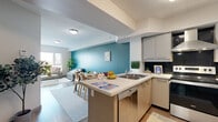 Located at 254 Phillip Street in Waterloo, Ontario, this well-appointed unit offers five bedrooms and four bathrooms across a generous, single-level floor plan. The modern kitchen is outfitted with stainless steel appliances, including a full-size refrigerator, electric range with a stainless hood vent, and dishwasher. Sleek grey cabinetry, a dark tile backsplash, and a peninsula with countertop seating create a practical and stylish cooking space with tile flooring underfoot. The open living area flows naturally from the kitchen and is distinguished by a bold teal accent wall, light wood-style flooring, and ample room for comfortable seating arrangements. Several bedrooms offer large windows with city and neighbourhood views, filling the rooms with natural light. The spacious primary bedroom provides a calm, neutral palette with wood-style flooring and generous storage. Additional bedrooms include options suited for shared occupancy, featuring sturdy bunk bed configurations and good natural light. The four bathrooms are clean and functional, each equipped with glass-enclosed showers and tile flooring. A connecting hallway ties all rooms together efficiently. This unit offers a practical, modern living environment well-suited for group or shared occupancy in the heart of Waterloo.