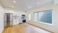 Located at 901 Leland St in Philadelphia's vibrant 19130 zip code, this efficiently designed one-bedroom, one-bathroom unit offers a thoughtfully planned layout with modern finishes throughout. Light hardwood flooring flows seamlessly across the entire space, enhancing the bright, airy atmosphere created by recessed lighting and generously sized windows.

The open kitchen and living area forms the heart of the unit, featuring crisp white shaker cabinetry, a marble-style tile backsplash, and a full suite of stainless steel appliances including a refrigerator, range, microwave, and dishwasher. Large windows flood the living area with natural light, adding to the sense of openness.

The bedroom is a calm, well-lit retreat with multiple windows offering natural light and two closets for ample storage. A dedicated laundry area adds everyday convenience.

The bathroom showcases stylish, contemporary design with large-format marble-look floor tiles, a wood-toned vanity with a white countertop, matte black fixtures, and a tub-shower combination with bold marble-patterned surround tile. Clean white walls and modern hardware complete the polished look. This unit offers a well-appointed, move-in-ready living experience in a compact yet functional footprint.