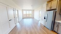 This contemporary apartment in Fargo, North Dakota, offers 940 square feet of thoughtfully designed living space. The layout includes two bedrooms, two full bathrooms, and an open-concept kitchen and living area. The primary bedroom is generously sized at 160 square feet, providing ample space for relaxation.

The interior boasts a fresh, modern aesthetic with neutral tones and clean lines. Large windows in the bedrooms and living area flood the space with natural light and offer scenic views of the surroundings. The flooring transitions seamlessly from warm hardwood in the main living areas to plush carpeting in the bedrooms, enhancing comfort and style.

The kitchen is a highlight, featuring sleek cabinetry, stainless steel appliances, and a stylish hexagonal tile backsplash. The bathrooms are well-appointed with modern vanities, illuminated mirrors, and spacious showers. Additional amenities include in-unit laundry facilities and ample closet space with wire shelving systems.

Located at 1321 17th Ave S in Fargo, this apartment combines urban convenience with contemporary design, making it an ideal choice for those seeking a comfortable and stylish living environment.