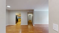 Located in Nashville's Bellevue neighborhood, this single-story, 4-bedroom, 2-bathroom home offers a practical and well-organized layout. Warm hardwood flooring runs throughout the entire space, lending a cohesive, inviting feel to every room. The living area is bright and open, highlighted by French doors that fill the room with natural light and provide direct outdoor access. A central hallway connects the living spaces to the bedrooms, ensuring a smooth flow throughout the home. The kitchen is efficiently designed with light maple cabinetry, dark granite-style countertops, a stainless steel sink, and black appliances including a range and over-the-range microwave. Both bathrooms feature warm wood vanities with white countertops, large mirrors, and hardwood flooring. The primary bedroom offers a comfortable footprint with a natural light source from a window. A dedicated closet with wire shelving provides organized storage. The additional bedrooms are well-sized with neutral tones and hardwood floors, making them versatile spaces. With a clean, neutral palette throughout, this home is move-in ready and well-suited for a variety of living arrangements.