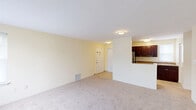 This one-bedroom, one-bathroom residence in Upper Chichester, Pennsylvania offers a practical and efficiently designed single-floor layout. The open-concept living area is finished with soft neutral tones on the walls and plush wall-to-wall carpeting, creating a warm and inviting atmosphere. Natural light filters in through multiple windows fitted with blinds, brightening the space throughout the day.

The kitchen is a functional highlight of the residence, featuring rich dark-wood cabinetry that extends to the upper walls for ample storage, granite-style countertops, and a full suite of stainless steel appliances including a refrigerator and dishwasher. Ceramic tile flooring anchors the kitchen, while a breakfast bar seamlessly connects it to the living area, enhancing the open feel of the shared space.

The bedroom is generously proportioned, offering soft carpeting, dual windows that allow for natural light, and a wide sliding-door closet providing substantial storage. The full bathroom is clean and well-appointed, featuring a tiled tub-shower combination, a toilet, and tile flooring. Throughout the residence, a consistent cream-toned color palette and straightforward design create a cohesive, move-in-ready environment suitable for comfortable everyday living.