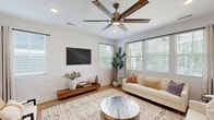 This 1,630 square foot single-story residence in Cornelius, NC, offers a thoughtful layout with 3 bedrooms and 4 bathrooms. The home's design emphasizes openness and functionality, with a combined kitchen, dining, and living area that forms the heart of the house. The kitchen boasts crisp white cabinetry, stainless steel appliances, and a gas range, all complemented by warm wood flooring that extends throughout the main living areas.

The primary bedroom, spanning 190 square feet, provides a serene retreat with ample natural light and a spacious en-suite bathroom. Two additional bedrooms offer comfortable accommodations, each with its own design aesthetic. The bathrooms feature modern fixtures, with at least one showcasing a combination of white cabinetry and wood-look flooring.

A dedicated laundry room adds convenience, while the attached garage, complete with an automatic door opener, houses a golf cart, hinting at nearby leisure activities. The dining area, adorned with nature-inspired artwork and a rustic table, creates an inviting space for meals.

The living room is a testament to contemporary design, with large windows, a striking ceiling fan, and a harmonious blend of textures in its furnishings. Throughout the home, neutral tones dominate, creating a calm and cohesive atmosphere that's punctuated by carefully chosen artwork and greenery.

This property combines modern amenities with thoughtful design, offering a comfortable and stylish living environment in a desirable North Carolina location.