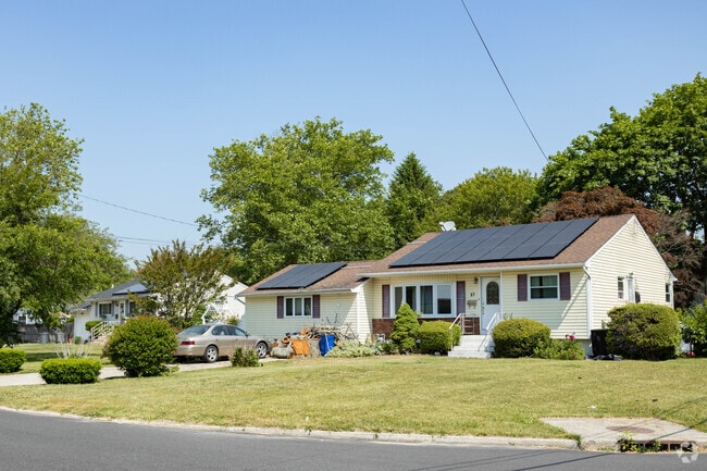 Solar panels on the roofs of ranch-style homes are common in Brentwood, New York.