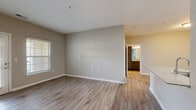 Located at 961 Seven Oaks Blvd in Smyrna, TN, this one-bedroom, one-bathroom residence offers a well-designed single-floor layout with a cohesive, modern aesthetic throughout. The living area features durable wood-style flooring, neutral warm-toned walls, and a glass-panel door flanked by windows that invite abundant natural light and outdoor views — creating a bright, welcoming atmosphere. The open-concept kitchen is a standout feature, equipped with gray shaker-style cabinetry, granite stone countertops, a peninsula with an undermount sink, and a full suite of stainless steel appliances including a refrigerator, range, microwave, and dishwasher. A dedicated dining area flows naturally from the kitchen. The bedroom is finished with plush carpeting, a ceiling fan, and a window overlooking the outdoors. It connects to a generously sized walk-in closet outfitted with built-in wire shelving and its own window. The full bathroom features a granite-topped vanity with dark cabinetry, a tiled tub/shower combo, and wood-style flooring. Additional conveniences include a dedicated laundry area and utility room, completing this thoughtfully designed and move-in-ready home.