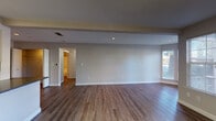 Located at 355 N Wolfe Rd in Sunnyvale, California, this single-floor residence offers a well-designed layout with a clean, modern aesthetic throughout. The open living area is finished with rich hardwood-style flooring and neutral gray walls, creating a bright and inviting atmosphere. A standout feature is the fireplace with a classic white mantel, flanked by windows dressed with horizontal blinds that allow natural light to filter in. Recessed lighting and a tray ceiling detail add architectural dimension to the living space.

The kitchen is thoughtfully designed with white cabinetry, dark countertops, a tile backsplash, and stainless steel appliances including a range and microwave. A peninsula with bar-height seating potential opens seamlessly to the main living area, making it ideal for everyday use. A louvered pantry door provides practical storage within the kitchen.

The bedrooms are carpeted for comfort and feature large windows that bring in natural light. Ample closet access is evident from the multiple doorways visible in each room. The bathroom is equipped with white cabinetry, a dark countertop vanity with a mirror, and a full tub-shower combination, all finished with hardwood-style flooring for a cohesive look.