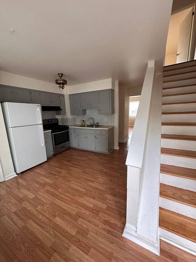 View of kitchen and stairs to second floor bedrooms from backdoor (parking lot) - 163 S 4th Ave