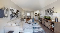 Located at 425 Merrimac Way in Costa Mesa, California, this single-story residence offers a well-designed, open-concept layout with modern finishes throughout. The living room is generously proportioned, featuring wood-style flooring, neutral toned walls, and a ceiling fan overhead. A large sliding glass door floods the space with natural light and provides direct access to an outdoor patio area, framing pleasant exterior views. The living area flows seamlessly into a dedicated dining space and an updated kitchen.

The kitchen is thoughtfully appointed with crisp white cabinetry, grey countertops, a subway tile backsplash, and a full suite of stainless steel appliances including a gas range, microwave, dishwasher, and refrigerator. A double-basin sink anchors the kitchen peninsula, making the space both functional and visually cohesive.

The bedroom is a calm, comfortable retreat with plush carpeting, soft neutral walls, and a window fitted with blinds that allow for adjustable natural light. The bathroom features a tub-shower combination, a white vanity with integrated sink, and wood-style flooring, while an adjacent closet provides convenient storage. Together, the spaces create a cohesive, move-in-ready home in a desirable Costa Mesa location.