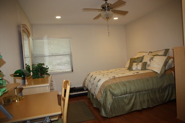 Bedroom 3 has full wall closet, laminate wood floors, and ceiling fan. - 2662 NW 42nd St