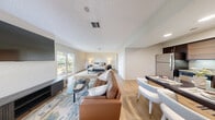 Located at 525 NW 77th St in Boca Raton, FL, this single-floor unit offers 2 bedrooms and 2 bathrooms with a thoughtfully designed open-concept layout. Light wood flooring runs throughout, complementing the warm, neutral color palette that creates a bright and welcoming ambiance.

The expansive primary bedroom is a standout feature, comfortably accommodating a full living area alongside the sleeping space. A sliding glass door provides direct access to the outdoors, filling the room with natural light and garden views. A large bifold closet adds ample storage, and a dedicated vanity area connects to the en-suite bathroom.

The open living and dining area flows naturally from the primary space, offering flexibility for various furniture arrangements. The kitchen is well-appointed with dark espresso cabinetry, granite countertops, stainless steel appliances — including a full-size refrigerator, dishwasher, microwave, and range — and under-cabinet lighting, accompanied by a dining area.

The second bedroom provides a quiet, private retreat, while both bathrooms are finished with clean, light tones and wood-look flooring. The textured ceilings and soft, neutral walls throughout lend the unit a cohesive, move-in-ready appeal suited for comfortable Florida living.