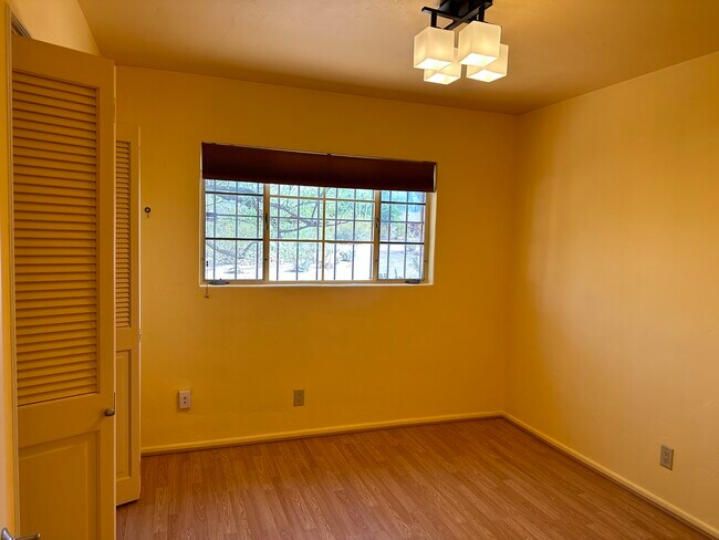 Bedroom 1: full bedroom with large hanging closet (7.5 ft), view to the north. Approx 10x10. - 1416 E Lind Rd