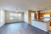 Located at 11575 Pearland Pkwy in Houston, TX, this single-story, 3-bedroom, 2-bathroom home offers a functional and comfortable layout across a well-utilized floor plan. The open-concept living room and kitchen area is bright and welcoming, featuring wood-style plank flooring, crown molding, and a ceiling fan. Large windows with blinds invite natural light and outdoor views, enhancing the airy feel of the space. The kitchen is equipped with warm honey-toned cabinetry, granite-style countertops, a kitchen island with a sink, and white appliances including a range, microwave, refrigerator, and dishwasher — all set atop classic tile flooring. The three bedrooms are carpeted and include ceiling fans and windows with outdoor views. The spacious primary bedroom features a walk-in closet with built-in shelving and wire rack storage. The bathrooms are finished with tile flooring, warm wood vanities, and ample counter space. A dedicated laundry room houses a full-size washer and dryer. Three hallways and three closets throughout the home provide generous storage. The neutral color palette and consistent finishes create a cohesive, move-in-ready environment.