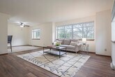 Located at 518 N High Point Rd in Madison, WI, this three-bedroom, three-bathroom home spans three floors, offering a well-organized and functional layout throughout. The main level welcomes you with a bright, open living room featuring warm hardwood flooring, a ceiling fan, and a large picture window that fills the space with natural light and views of the surrounding neighborhood. A carpeted staircase with a wood-trimmed railing connects the floors seamlessly. The kitchen is well-appointed with rich oak cabinetry, dark granite countertops, stainless steel appliances including a refrigerator, range, microwave, and dishwasher, and tile flooring. The dining area flows naturally from the kitchen, creating an open and connected living space. The upper level houses the bedrooms, including a generously sized primary bedroom with plush carpeting, a natural light-filled window with outdoor views, and a spacious walk-in closet outfitted with wood shelving and hanging rods. The three bathrooms are clean and functional, with at least one featuring a tub-shower combination with sliding glass doors and tile flooring. A dedicated laundry area includes a full-size washer and dryer with overhead shelving. The attached garage offers additional storage or parking space, while the unfinished basement provides significant potential for future use.